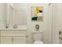 Clean bathroom with a white vanity and a framed print at 9650 Minnow Ray Dr, Land O Lakes, FL 34638