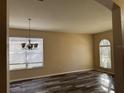 Spacious dining room featuring wood-look floors and a chandelier at 11321 Flora Springs Dr, Riverview, FL 33579
