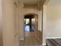 Long hallway with tile floors connecting to the living areas at 11321 Flora Springs Dr, Riverview, FL 33579