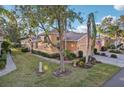House exterior with lush landscaping and palm trees at 1141 Jameson Greens Dr # 3, Sun City Center, FL 33573