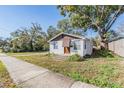 Cute one-story house with a sidewalk and mature trees at 14035 21St St, Dade City, FL 33525