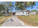 White house with carport and spacious backyard at 14035 21St St, Dade City, FL 33525