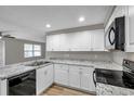 Modern kitchen with white cabinets, granite countertops, and stainless steel appliances at 16116 Sagebrush Rd, Tampa, FL 33618