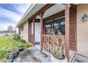 Front entrance with wooden posts and potted plants at 3411 28Th E St, Bradenton, FL 34208