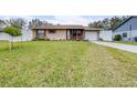 House with a neatly landscaped lawn and driveway at 3411 28Th E St, Bradenton, FL 34208