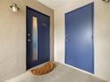 Condo building entrance with blue doors and a doormat at 3817 W Platt St # 306, Tampa, FL 33609