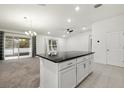 Open concept kitchen with island and granite countertops at 3946 Postmark Lake Pl, Seffner, FL 33584