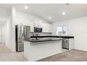Modern kitchen with island, granite countertops and stainless steel appliances at 3946 Postmark Lake Pl, Seffner, FL 33584