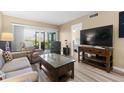 Living room with access to balcony and comfortable furniture at 6219 Palma Del Mar S Blvd # 114, St Petersburg, FL 33715