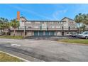 Two-story building with multiple units, garages, and ample parking at 6311 Newtown Cir # 11B1, Tampa, FL 33615