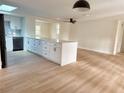 Open-concept kitchen with a large island, modern appliances, and sleek countertops at 6615 Parkside Dr, New Port Richey, FL 34653