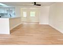 Bright open-concept living room featuring light wood flooring at 6615 Parkside Dr, New Port Richey, FL 34653