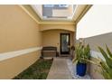 Front entry with a bench and potted plants at 8907 Casablanca Way, Tampa, FL 33626