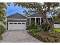 Gray house with white garage door and landscaping at 930 Monterey Ne Pt, St Petersburg, FL 33704
