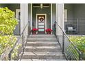 Front entrance with stone steps and modern railings at 930 Monterey Ne Pt, St Petersburg, FL 33704