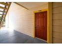 Condo building entry with red door and yellow trim at 11901 4Th N St # 9105, St Petersburg, FL 33716