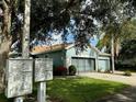 Exterior view of a house with a two-car garage and community mailboxes at 1213 Huntington Greens Dr, Sun City Center, FL 33573