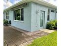 Side view of a house with a patio and additional storage area at 1213 Huntington Greens Dr, Sun City Center, FL 33573