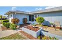 Front entrance with landscaping and a walkway leading to the door at 1613 Heather Pl, Palm Harbor, FL 34684