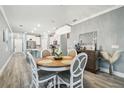 Bright dining room featuring a round wooden table and chandelier at 18015 Fenders Way, Land O Lakes, FL 34638