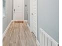 Light and airy hallway with wood-look tile flooring at 18015 Fenders Way, Land O Lakes, FL 34638