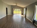 Spacious living room with wood-look floors and large windows at 18116 Portside St, Tampa, FL 33647