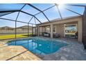 This home boasts a large, free-form screened pool at 18241 Romanesque Ct, Spring Hill, FL 34610