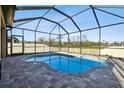 Inviting screened pool with a freeform design and ample patio space at 18241 Romanesque Ct, Spring Hill, FL 34610
