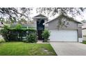 Two story house with a double garage and lush landscaping at 19130 Wood Sage Dr, Tampa, FL 33647
