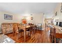 Bright dining room featuring hardwood floors and a view into the living room at 2101 Sunset Point Rd # 1102, Clearwater, FL 33765