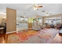 Open living room with hardwood floors, a view of the kitchen, and a cozy seating area at 2101 Sunset Point Rd # 1102, Clearwater, FL 33765