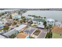 Aerial view of a waterfront community with colorful houses and boats at 306 180Th E Ave, Redington Shores, FL 33708
