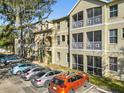 Building exterior showcasing parking and screened balconies at 5041 Sunridge Palms Dr # 103, Tampa, FL 33617