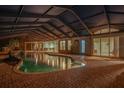 Inviting pool and spa area with covered patio, perfect for nighttime entertaining at 6114 Kingbird Manor Dr, Lithia, FL 33547