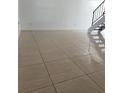 Bright living room with tile floors and staircase at 7638 Woodbridge Blvd, Tampa, FL 33615