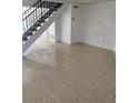 Bright living room with tile floors and staircase at 7638 Woodbridge Blvd, Tampa, FL 33615