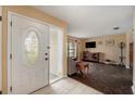Home entryway with a white door and view into the living room at 823 Scenic Heights Dr, Brandon, FL 33511