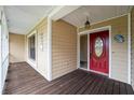 Wooden porch with a red front door and white railings at 823 Scenic Heights Dr, Brandon, FL 33511