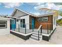 Modern deck with gray railings and blue door at 126 90Th Ave, Treasure Island, FL 33706