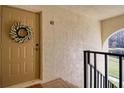 Inviting condo entry with wreath and view to a pond at 1488 Pine Glen Ln # B2, Tarpon Springs, FL 34688
