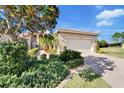 Well-maintained house with a paved driveway and lush landscaping at 15618 Aurora Lake Cir, Wimauma, FL 33598