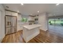 Renovated kitchen with island, stainless steel appliances, and white cabinets at 1566 Long St, Clearwater, FL 33755