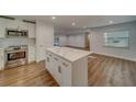 Modern kitchen with white cabinets, quartz countertops, and stainless steel appliances at 1566 Long St, Clearwater, FL 33755