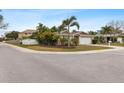 Single-story house on a corner lot with lush landscaping at 1700 Hibiscus N Cir, Oldsmar, FL 34677