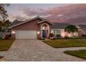 Attractive house with a paved driveway and well-manicured lawn at 1811 Stonebrook Ln, Safety Harbor, FL 34695