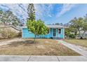 Charming light blue house with a manicured lawn and walkway at 1841 Overbrook Ave, Clearwater, FL 33755