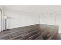 Spacious living room featuring dark laminate floors and an open floor plan at 2400 Feather Sound Dr # 127, Clearwater, FL 33762