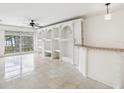 Spacious living room with built-in shelving and tile floors at 2700 Bayshore Blvd # 6308, Dunedin, FL 34698