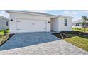 Front view of a single-story house with a two-car garage at 44305 Timberland Ter, Punta Gorda, FL 33982