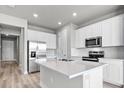 Island kitchen with stainless steel appliances and white cabinets at 44305 Timberland Ter, Punta Gorda, FL 33982